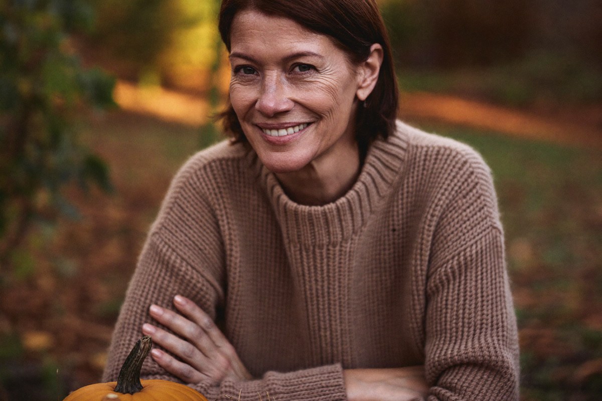 Frau genießt den Herbst im Garten